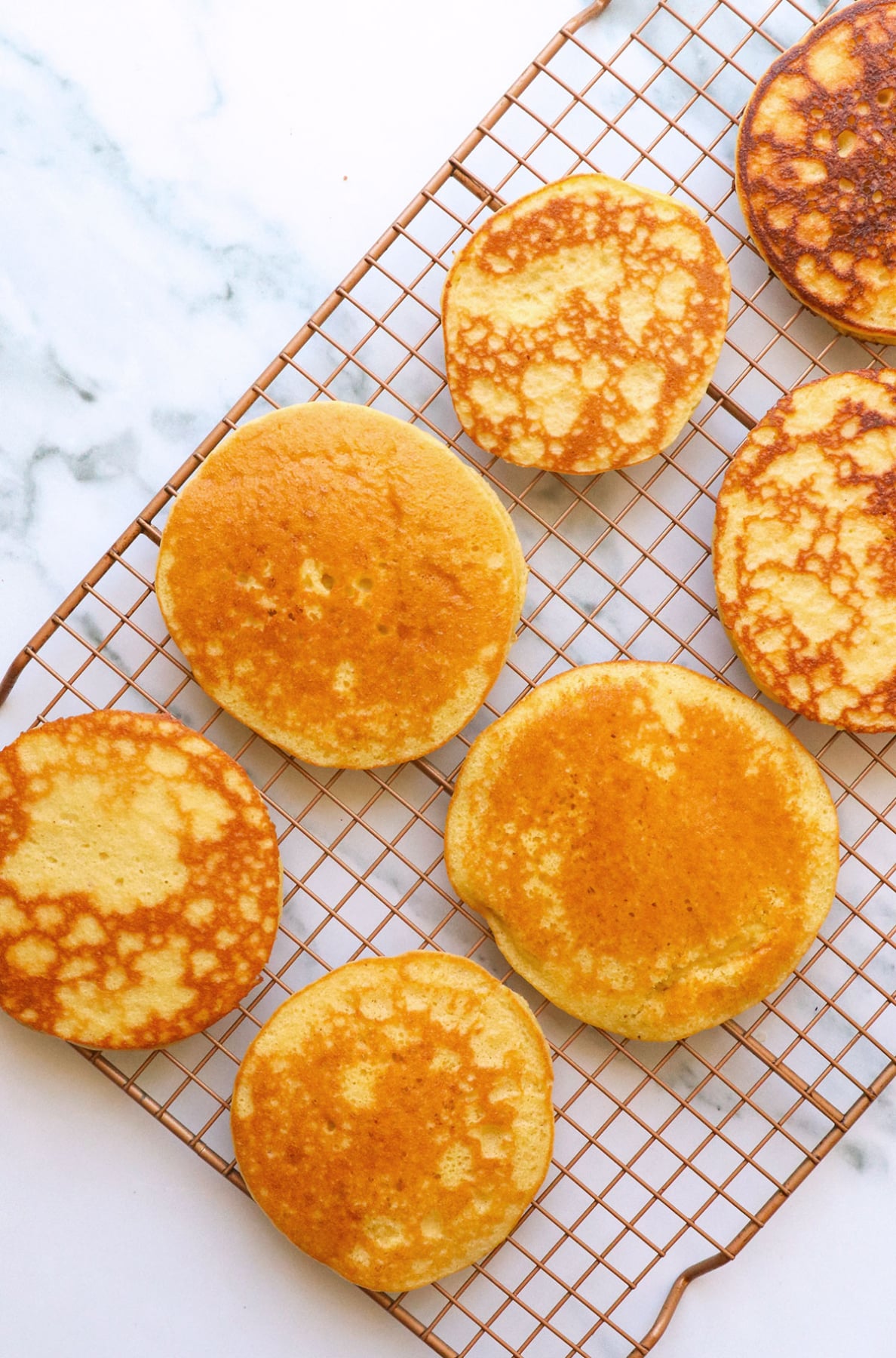 one batch of almond flour pancakes cooling on a wire rack.