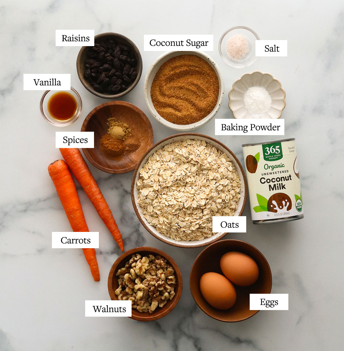 carrot cake baked oatmeal ingredients labeled on a marble surface.