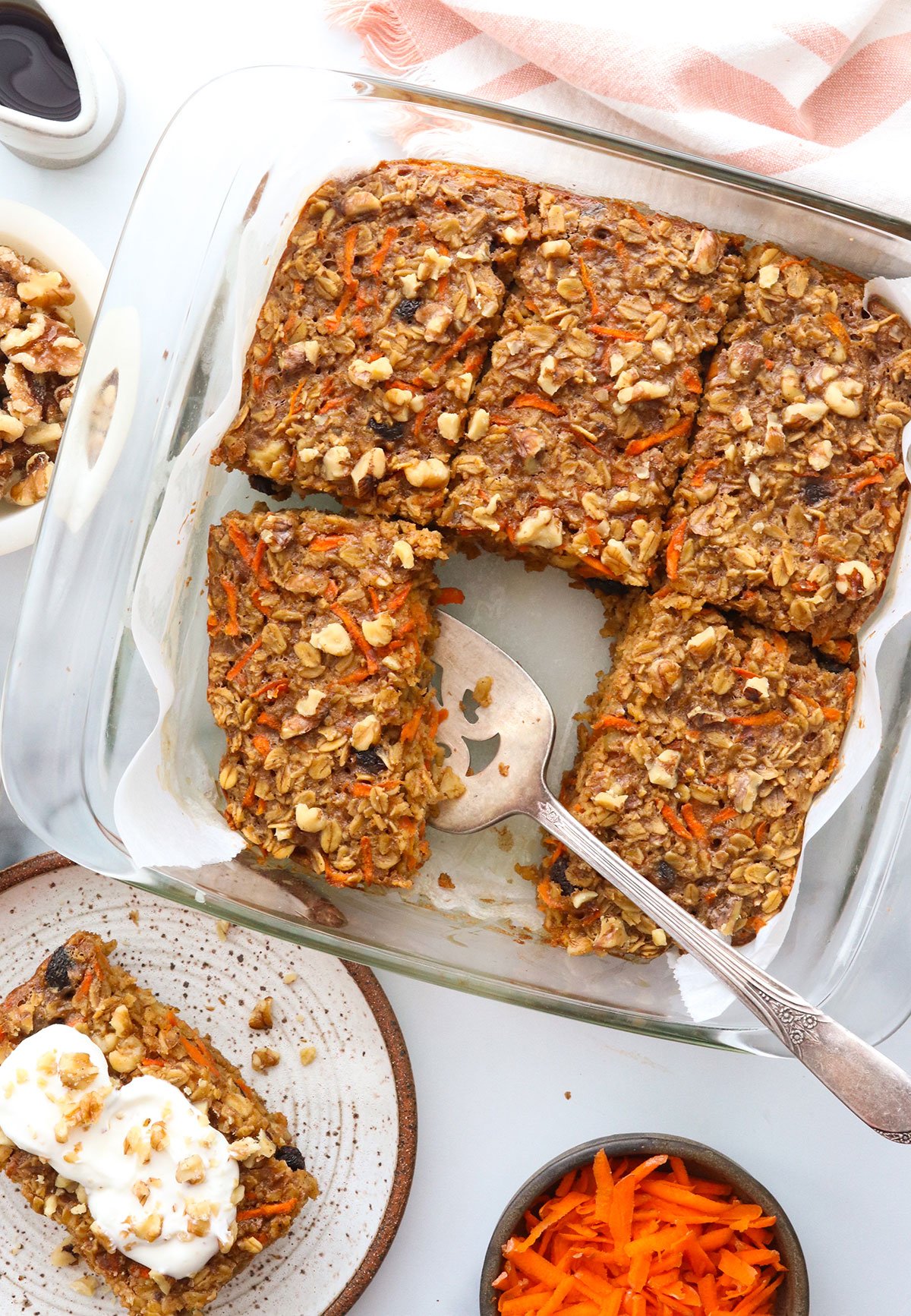 carrot cake baked oatmeal sliced and served from the pan.