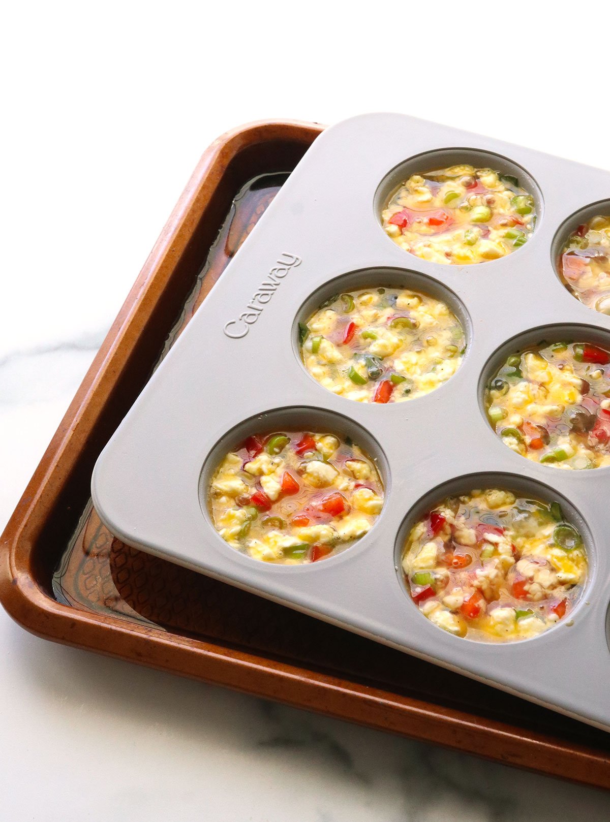 egg muffin pan set in a rimmed baking sheet of water.