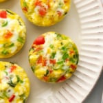 Egg muffins cooling on a white plate.