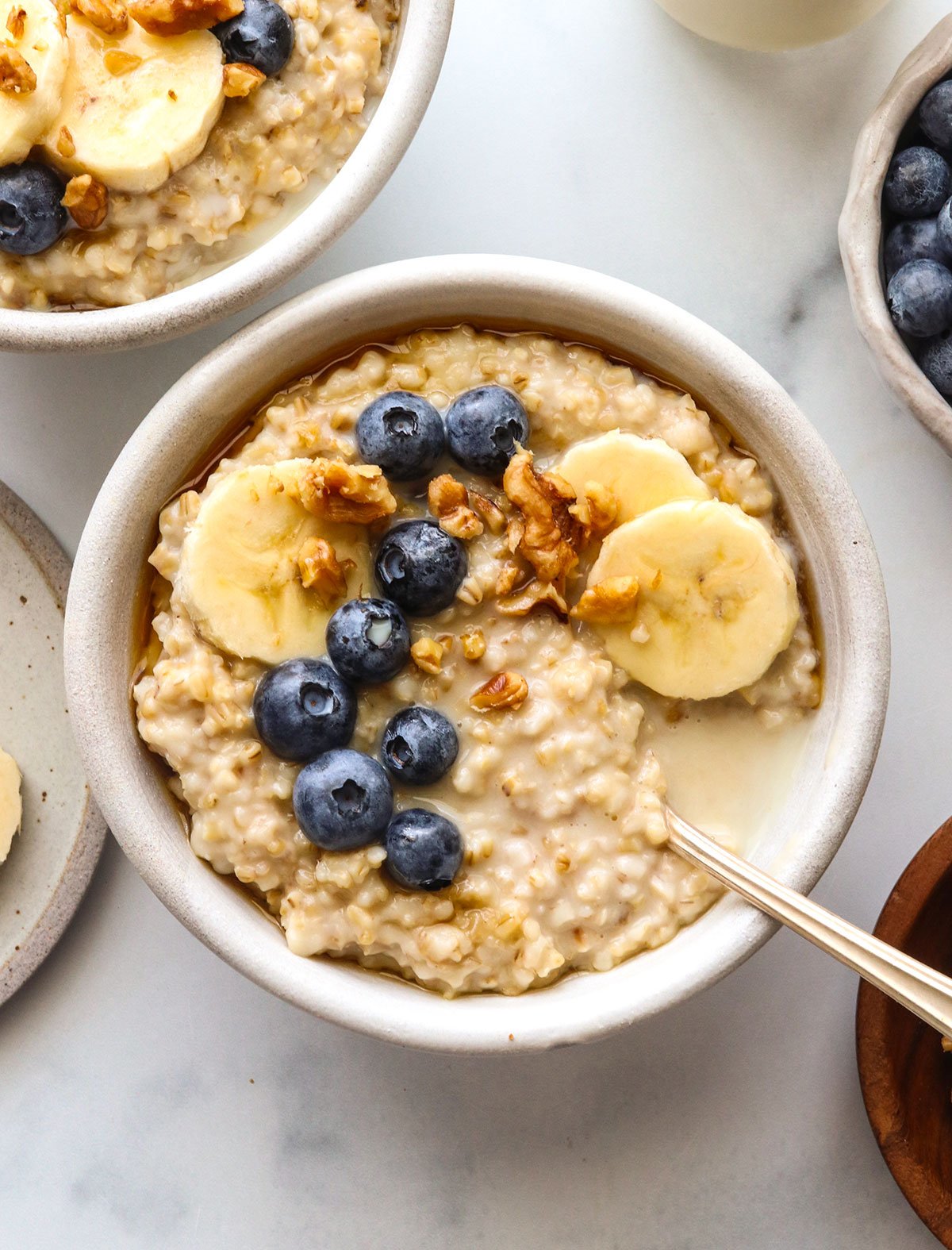instant pot steel cut oats with berries and banana on top.