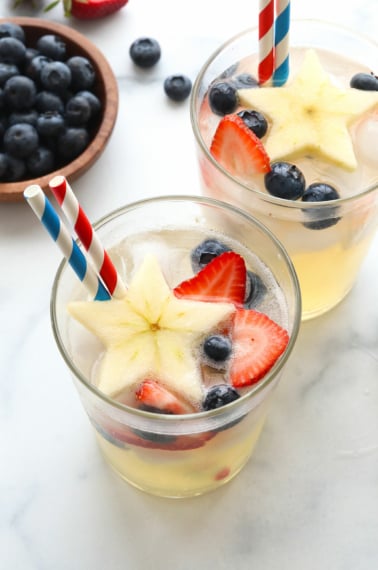 4th of july mocktails with red, white, and blue straws.