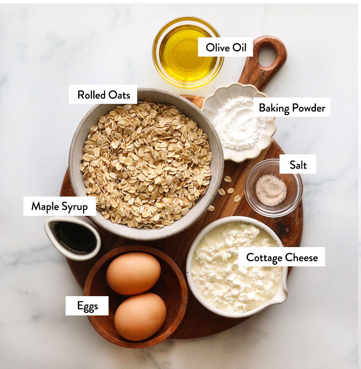 Bowl of cheese, oats, eggs and maple syrup mark in bowl.