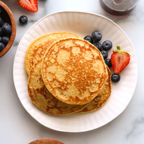 cottage cheese pancakes on a plate with berries.