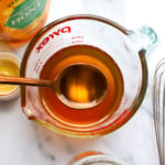 honey simple syrup lifted on a spoon.