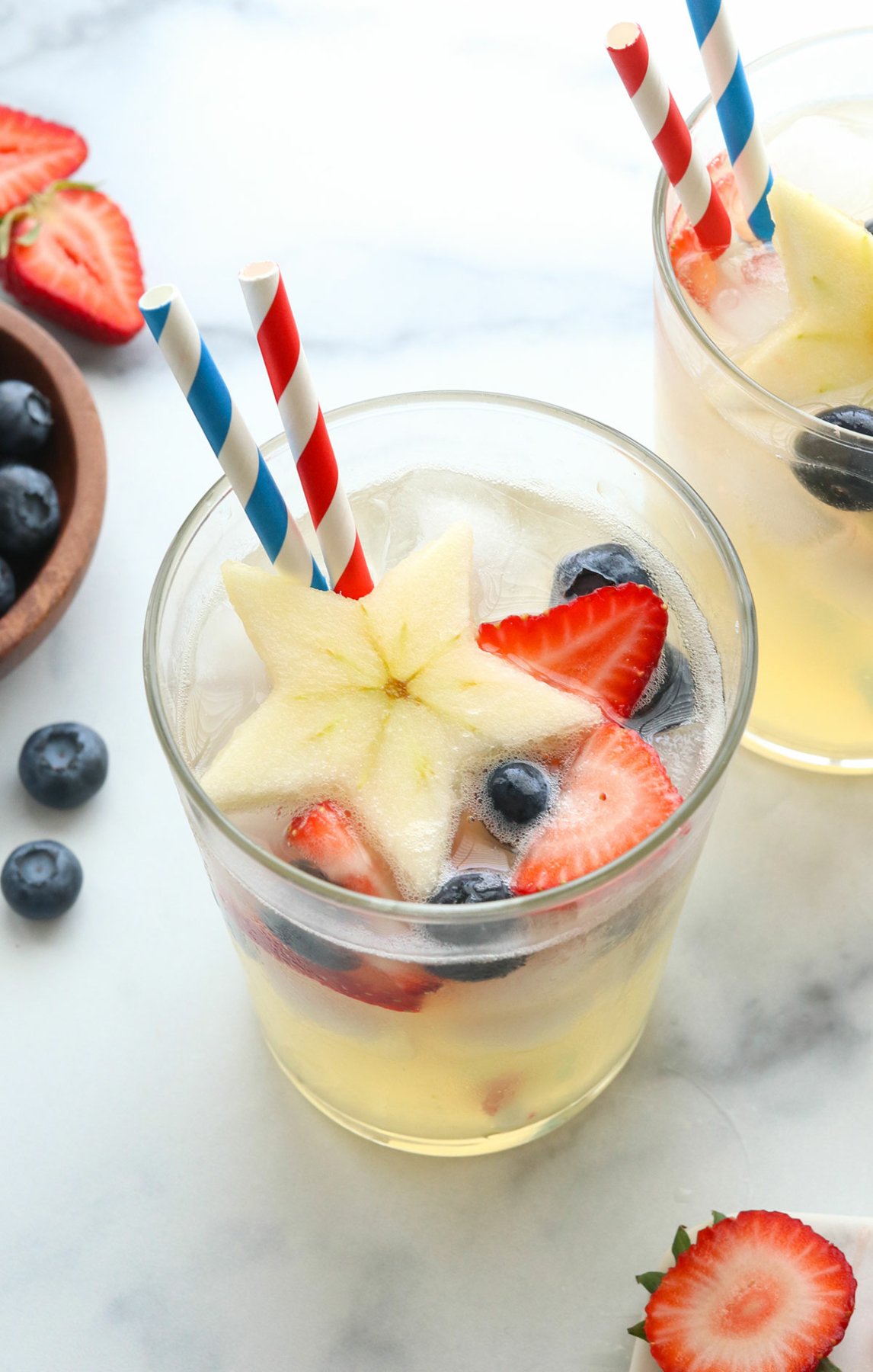 4th of july mocktail made with apple stars and berries.