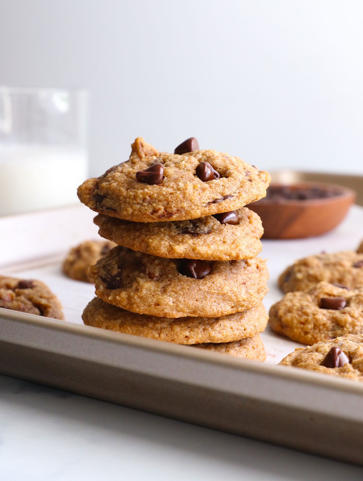 buckwheat cookies stacked on a baking sheet.