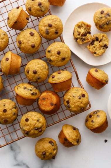 mini banana chocolate chip muffins cooling on a wire rack.