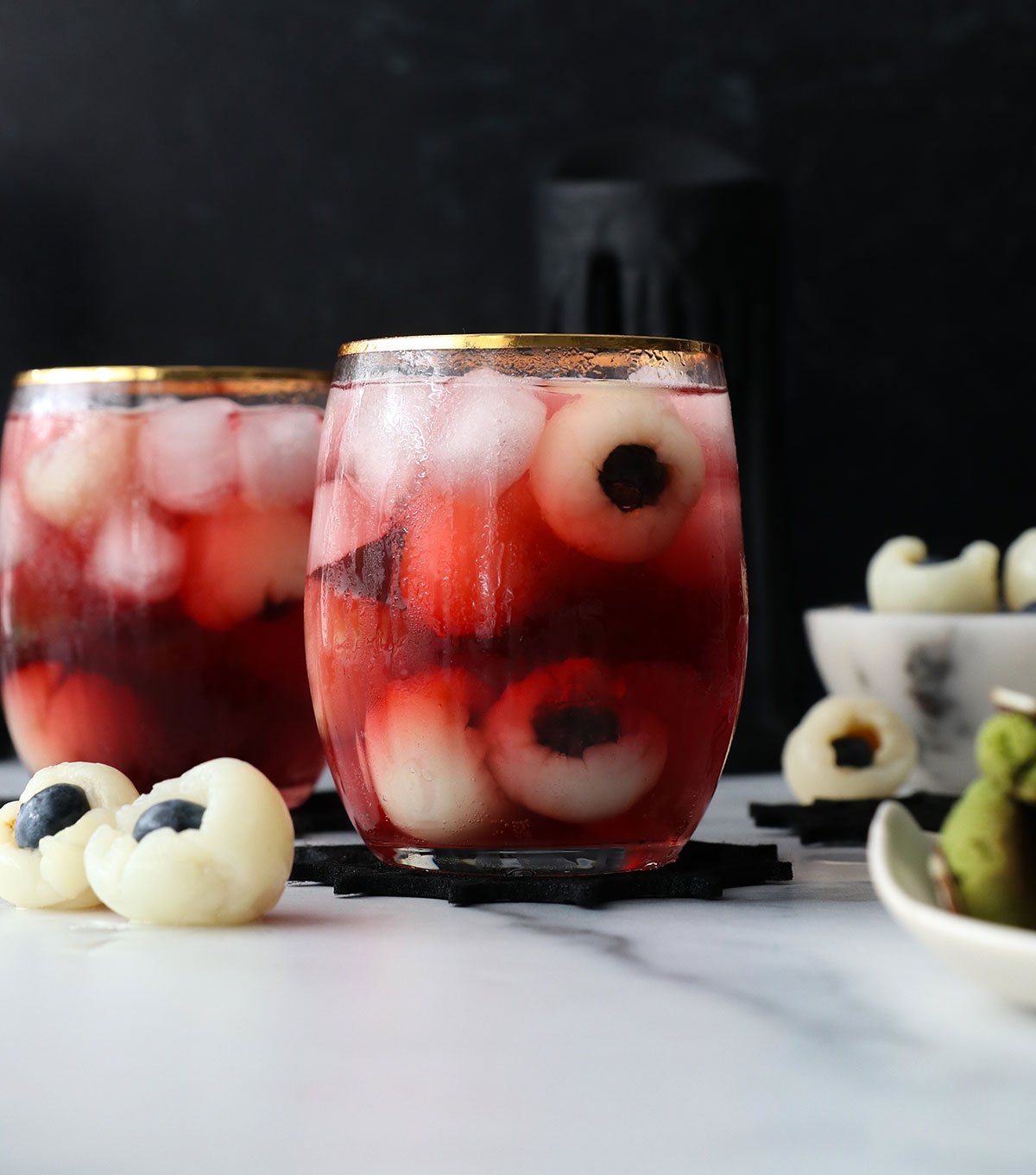 two glasses of lychee eyeball punch with a dark background.