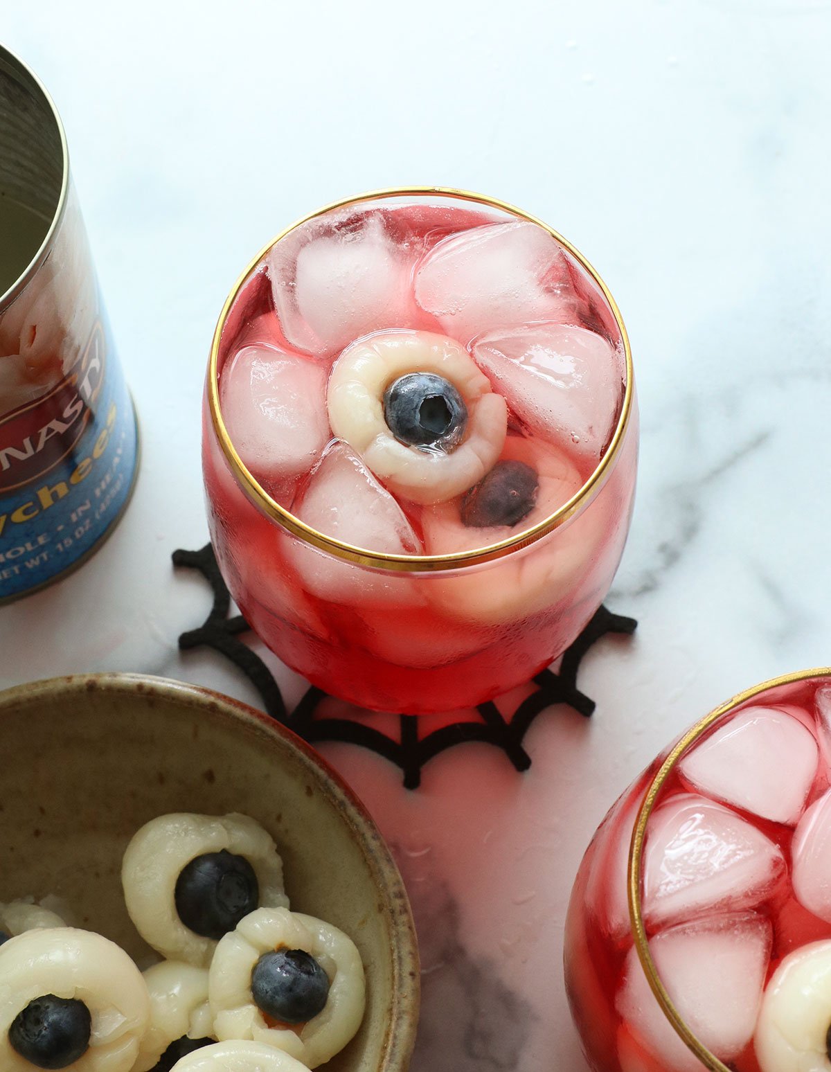 lychee eyeballs in a glass of red punch.