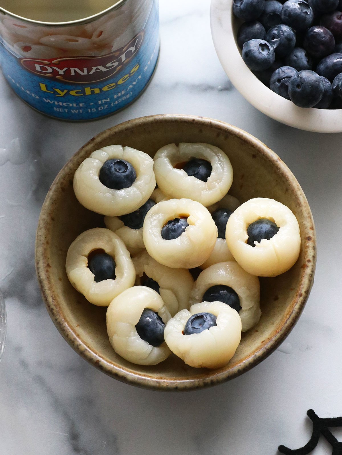 bowl of lychees stuffed with blueberries to look like eyeballs.