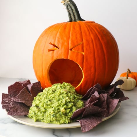 puking pumpkin served with guacamole and tortilla chips.