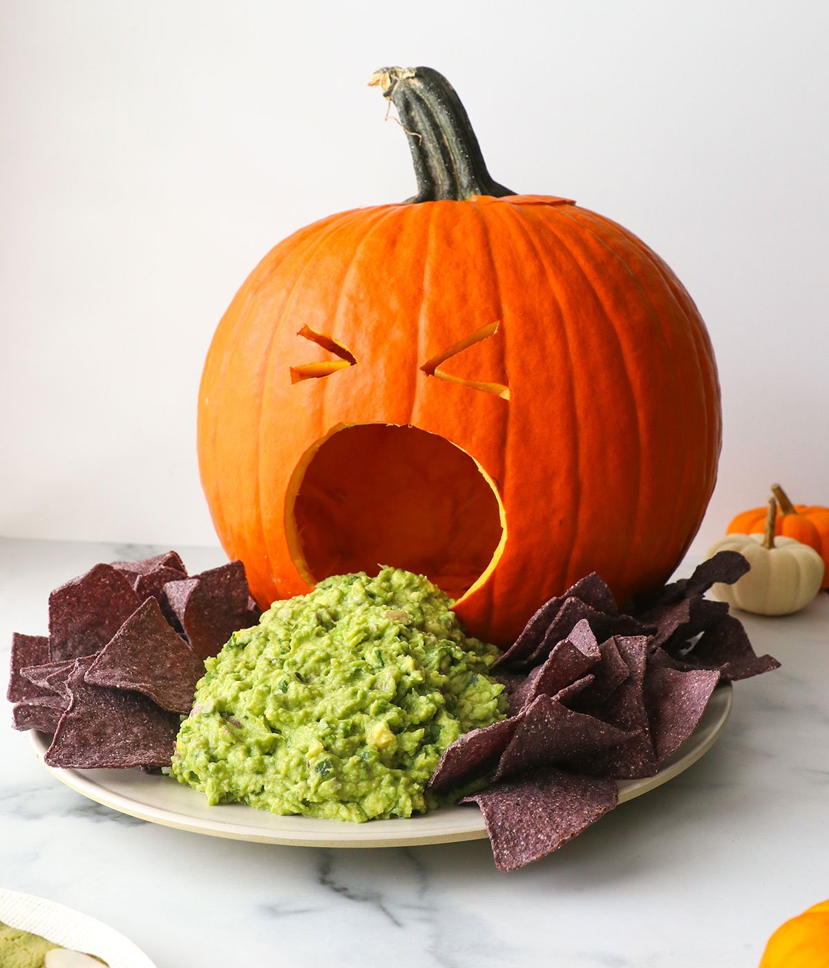 puking pumpkin served with guacamole and tortilla chips.