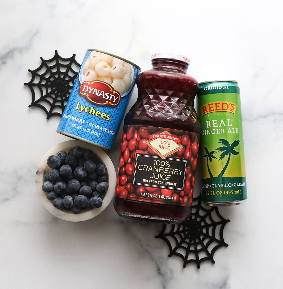 Halloween punch ingredients like cranberry juice, lychees, blueberries, and gingerale.