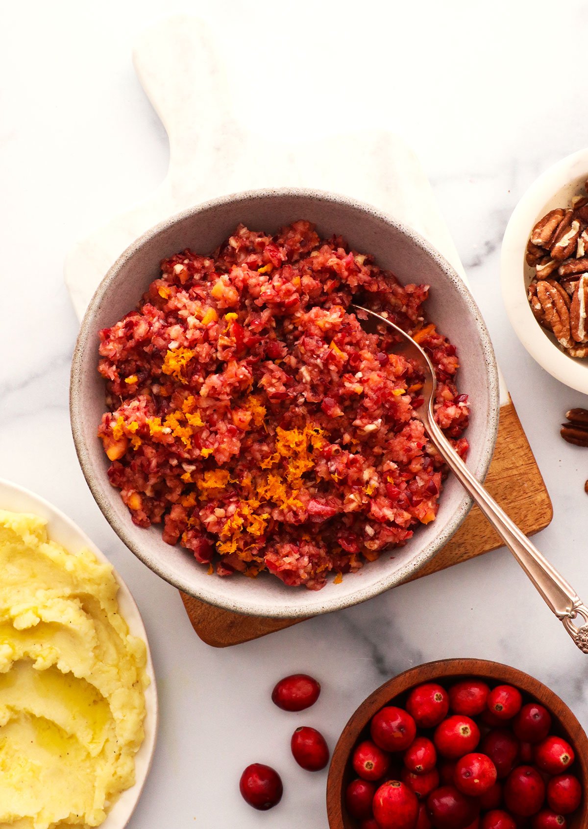 cranberry relish in a bowl near mashed potatoes.