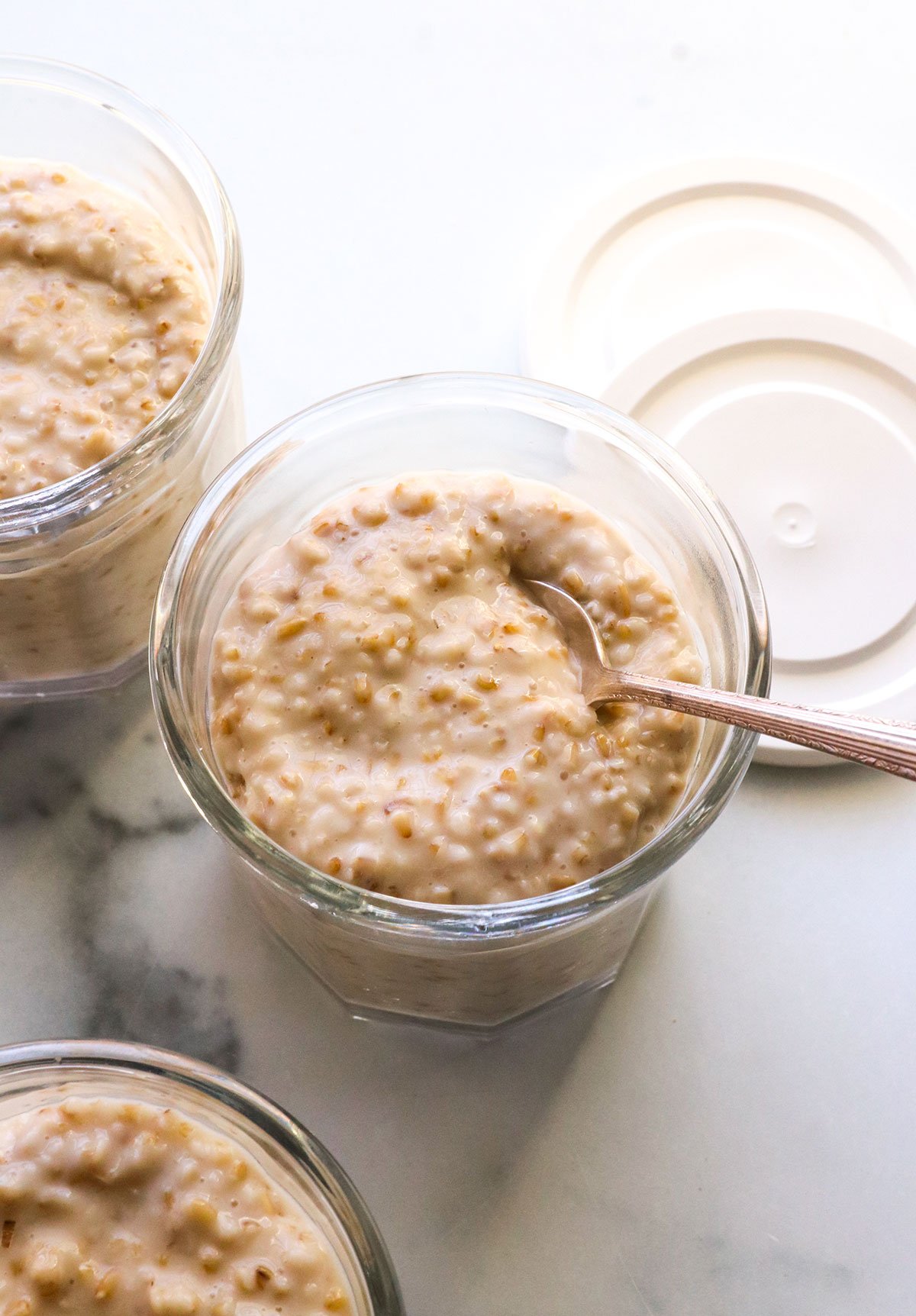 close up of the steel cut oats texture in a glass meal prep jar. 