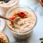 overnight steel cut oats topped with berries in a meal prep jar.