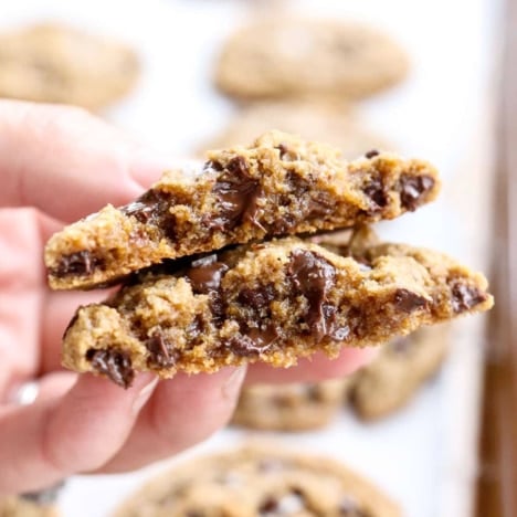 almond flour cookie split in half with melted chocolate chips.