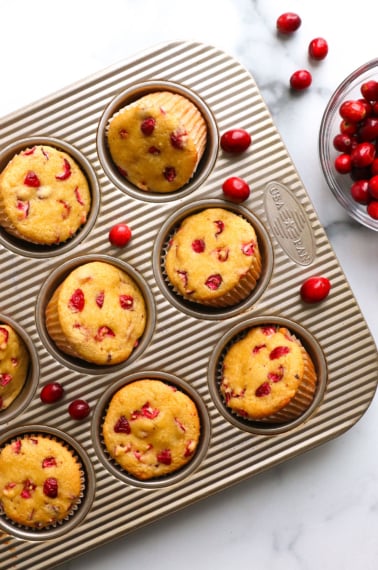 almond flour cranberry muffins cooled in a muffin tin.