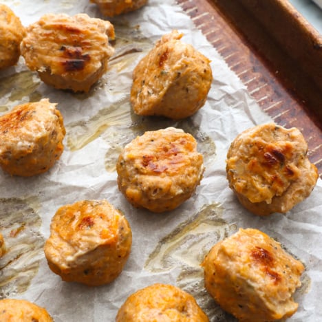 finished baked turkey meatballs on a lined pan.
