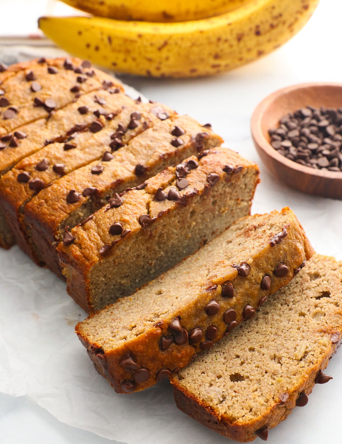 protein banana bread sliced and topped with mini chocolate chips.