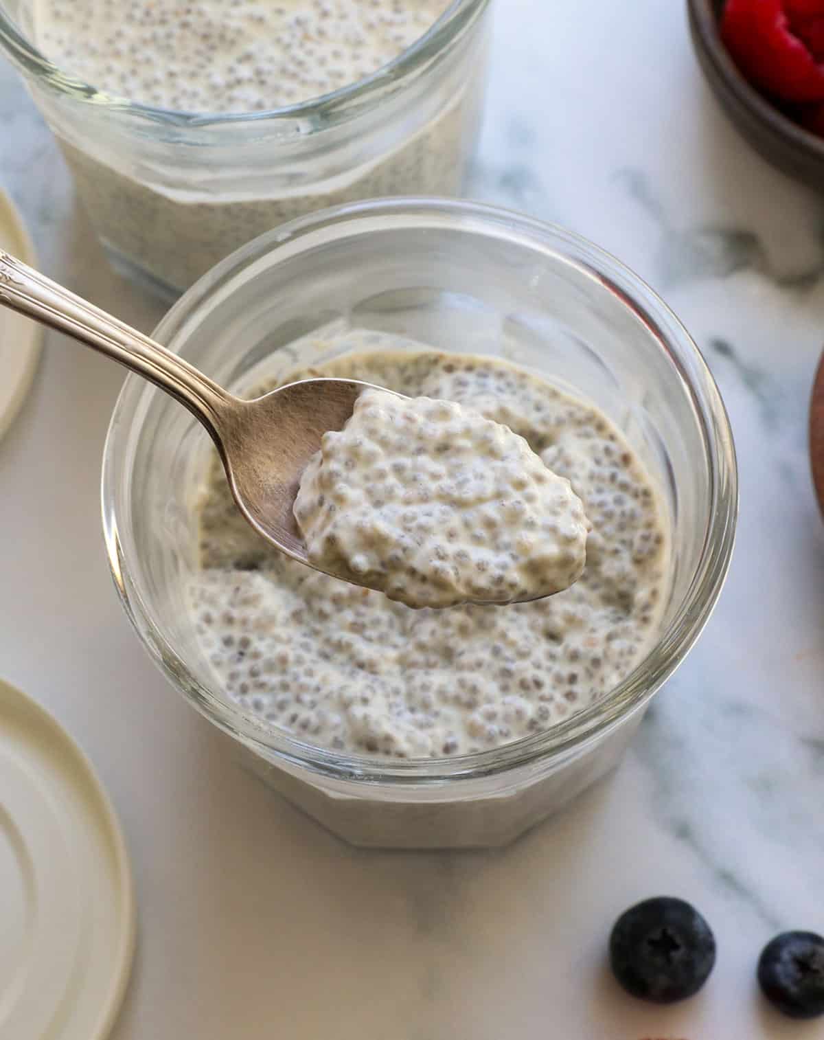 spoon lifting a bite of chia pudding to show the texture and thickness.