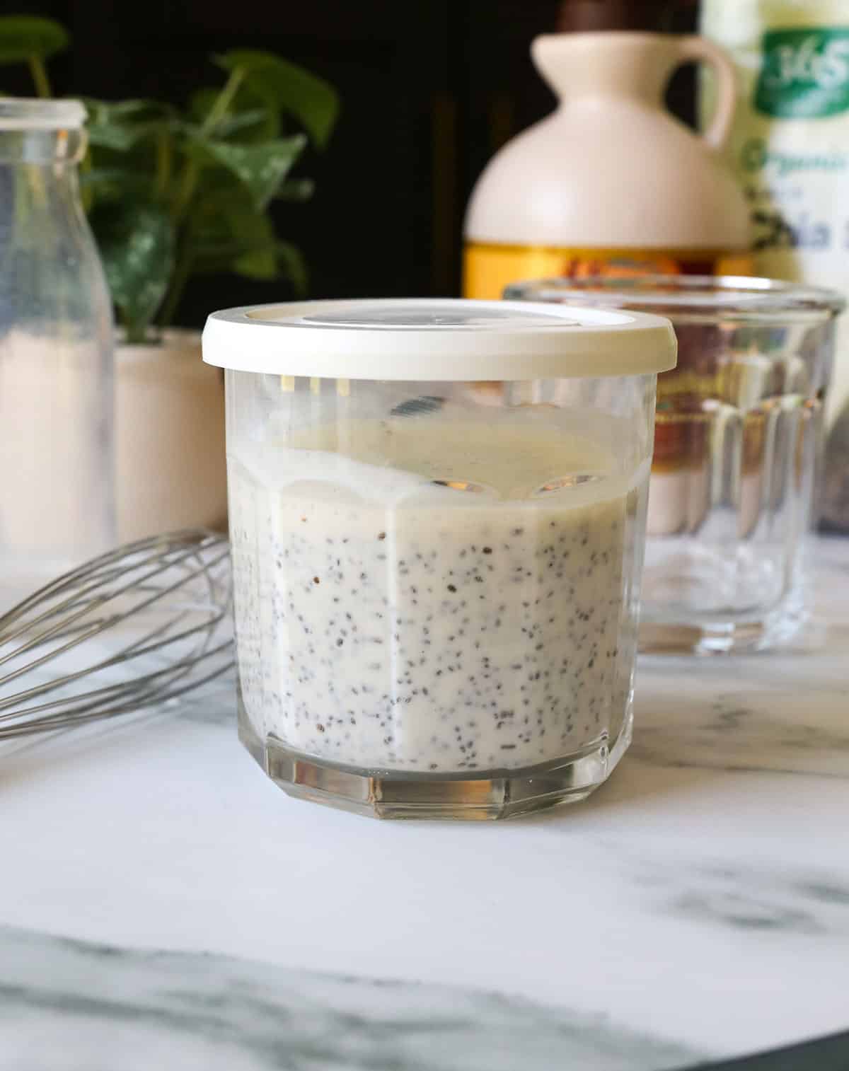 Glass storage jar sealed with a lid to store chia pudding.