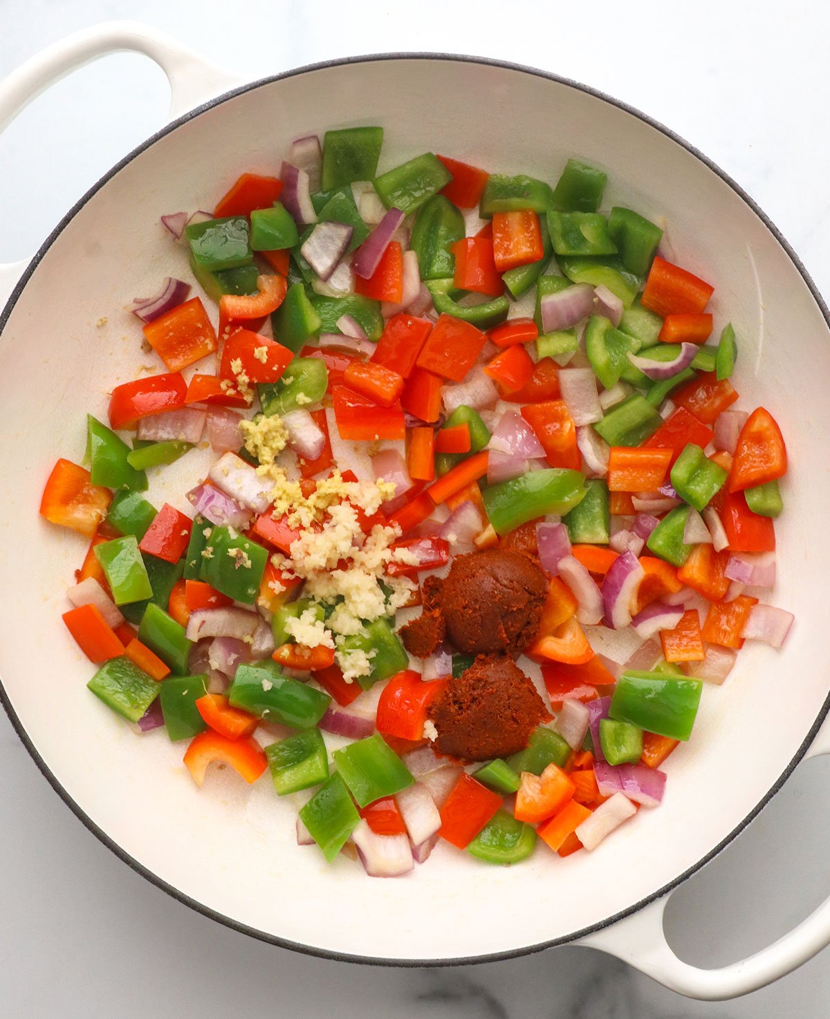 bell peppers and onions with curry paste, garlic, and ginger.