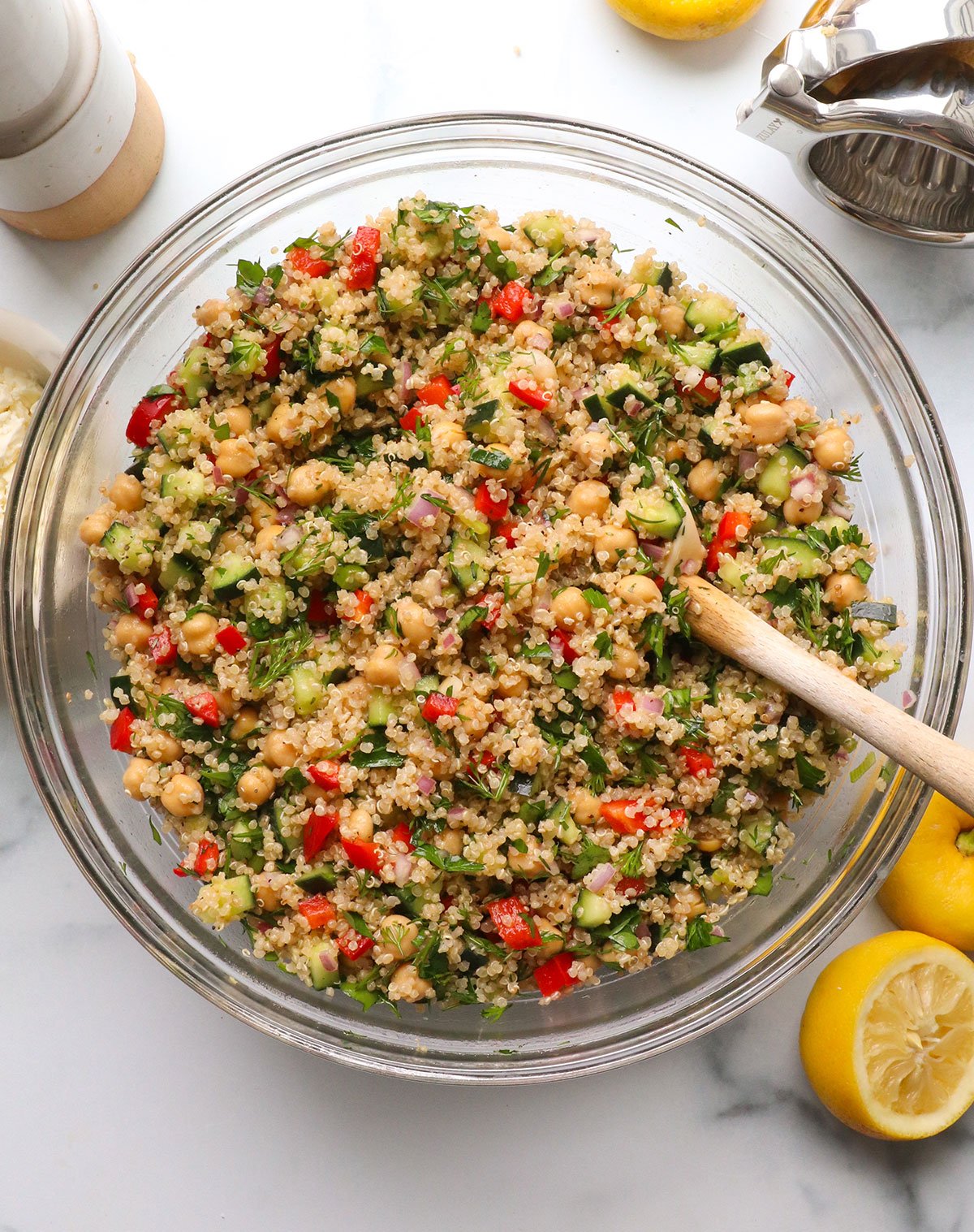 quinoa and chickpea salad mixed in a glass bowl.