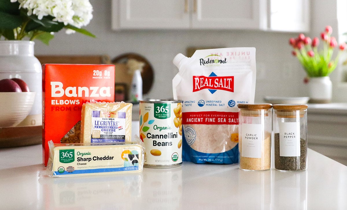 cheese, canned beans, and spices on a kitchen counter.