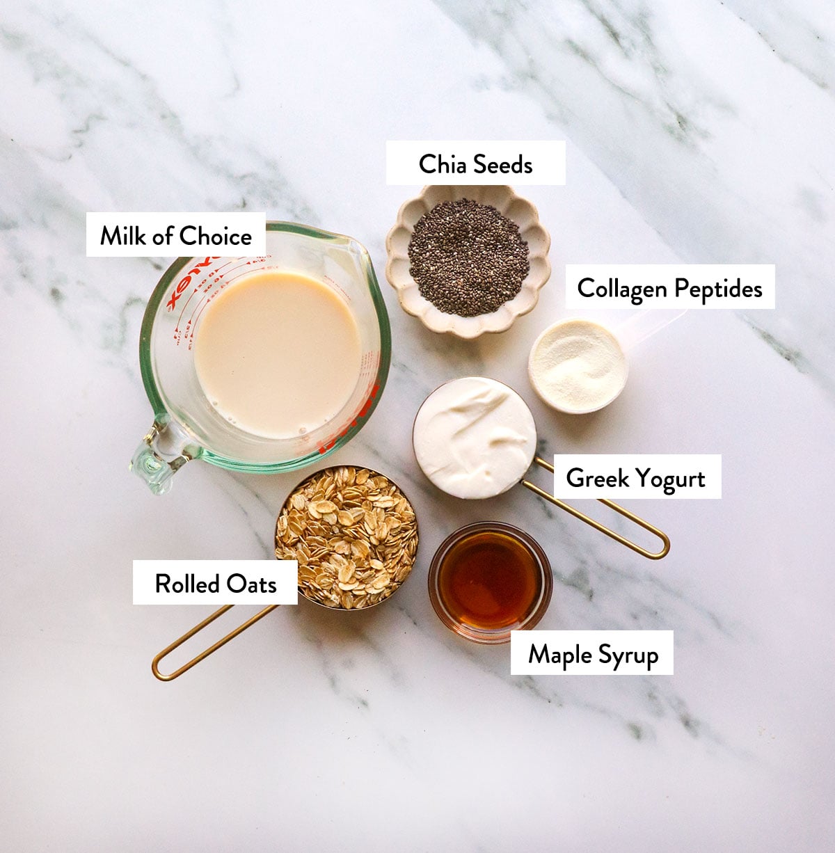 milk, oats, yogurt, maple syrup, and chia seeds labeled in bowls. 