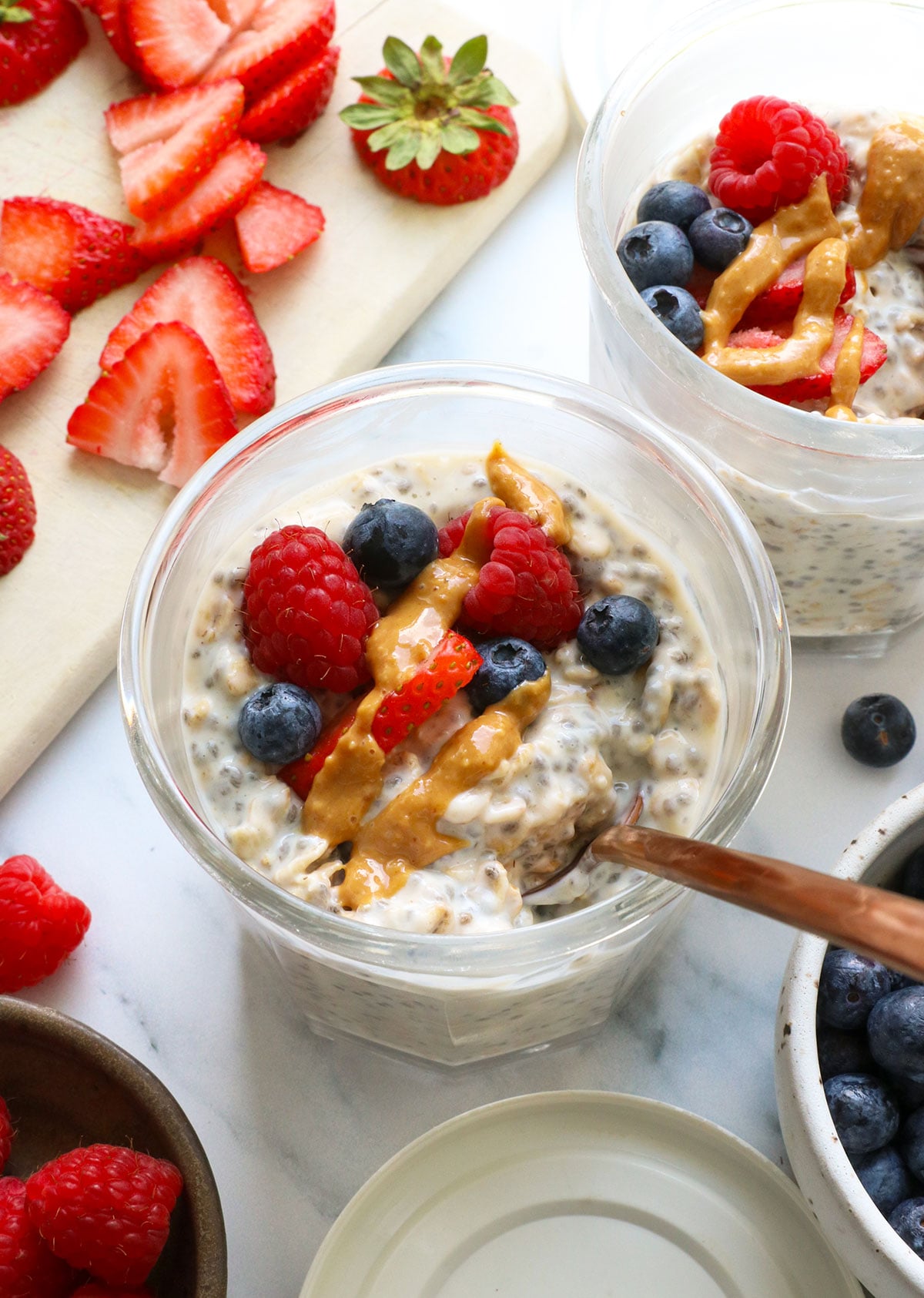 protein overnight oats topped with berries and peanut butter. 