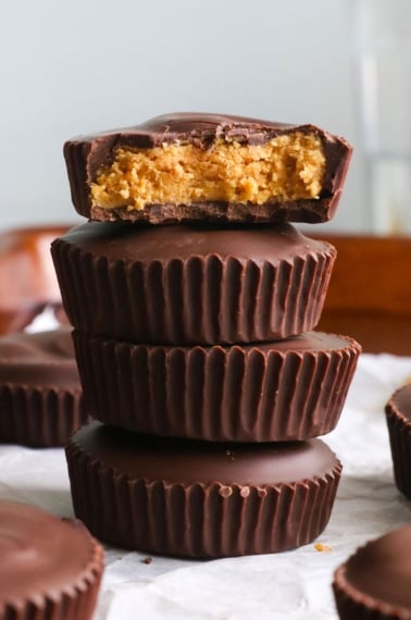 protein peanut butter cups stacked with the top one showing the center.