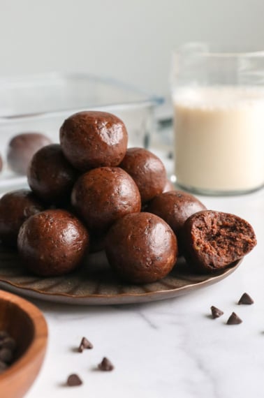 Chocolate protein balls with dates on a plate.