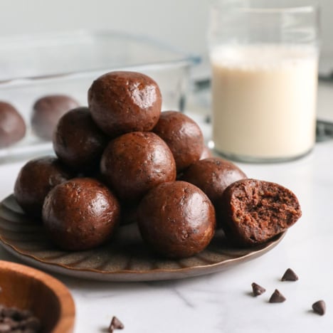Chocolate protein balls with dates on a plate.