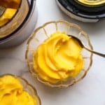 mango sorbet in two glass bowls by the Ninja Creami.