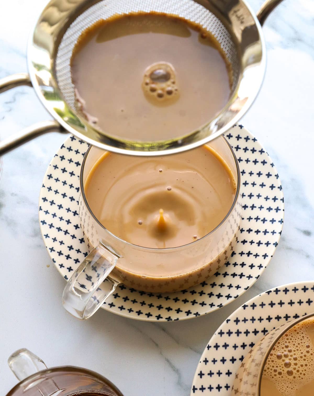chai latte strained and ready to serve warm in a glass mug.