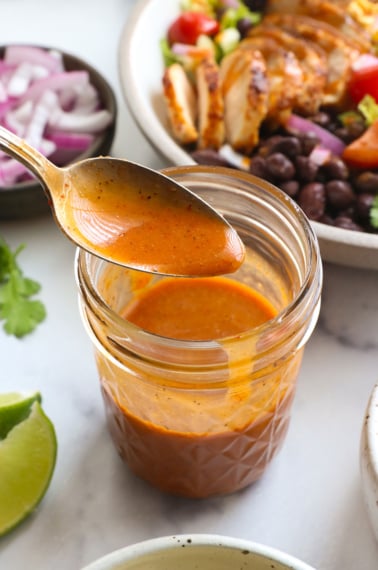 chipotle vinaigrette on a spoon over a dressing jar.