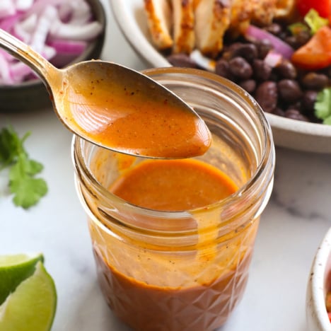 chipotle vinaigrette on a spoon over a dressing jar.