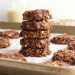healthy no bake cookies stacked on a pan.
