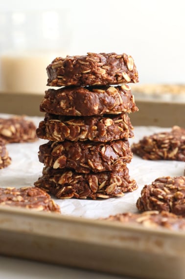 healthy no bake cookies stacked on a pan.