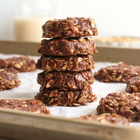 healthy no bake cookies stacked on a pan.
