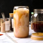 iced chai latte served in a cute glass with a black background.