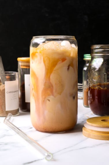 iced chai latte served in a cute glass with a black background.