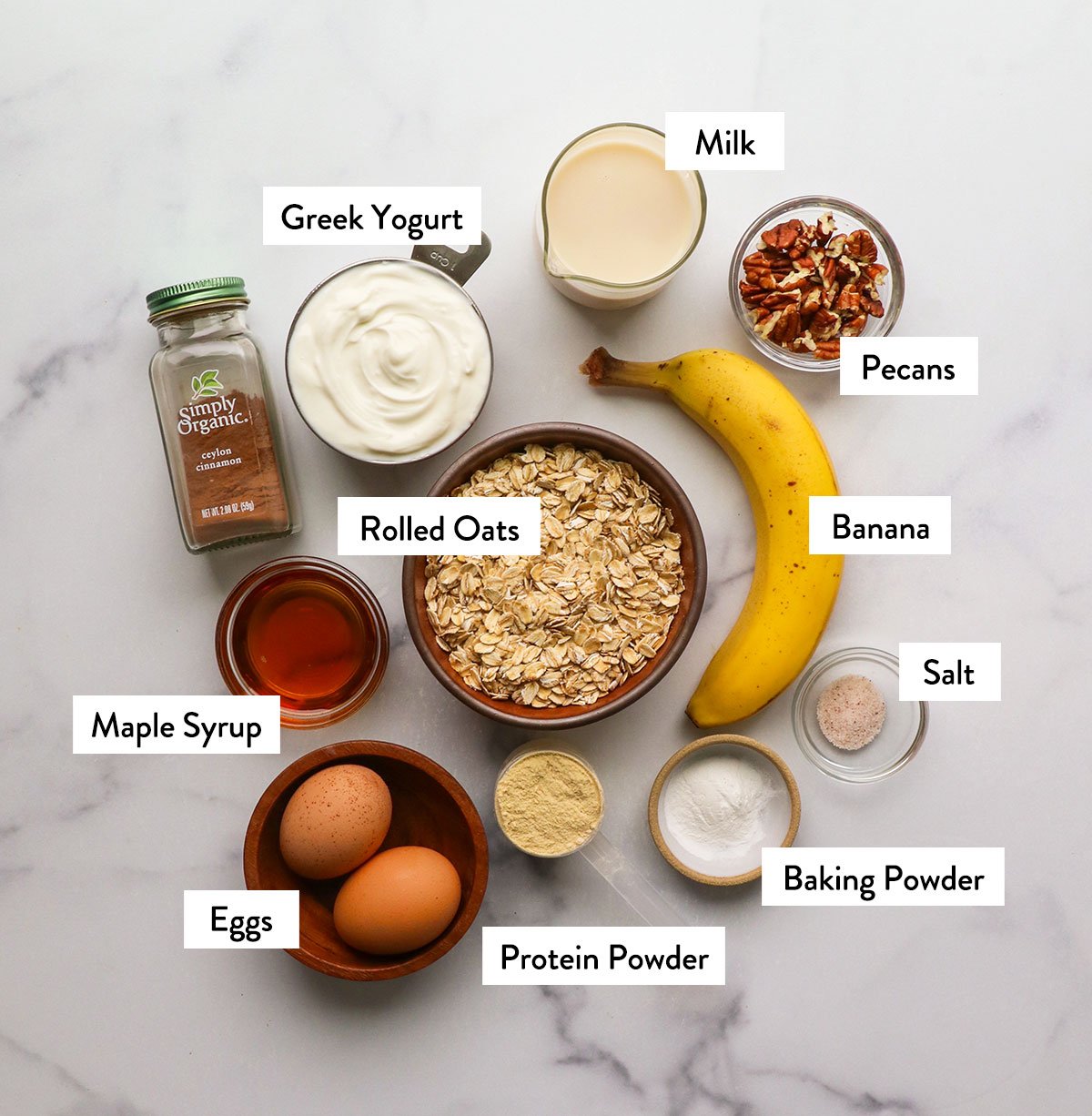 Oatmeal, banana, eggs, maple syrup, yogurt and milk mark in a bowl.