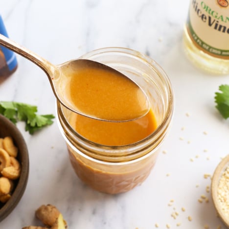 sesame ginger dressing lifted on a spoon.