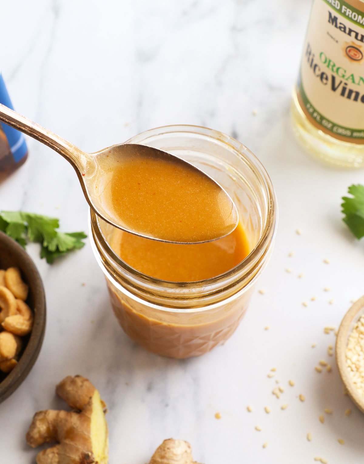 sesame ginger dressing lifted on a spoon. 