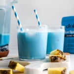 blue milk served in two glasses with blue striped straws.