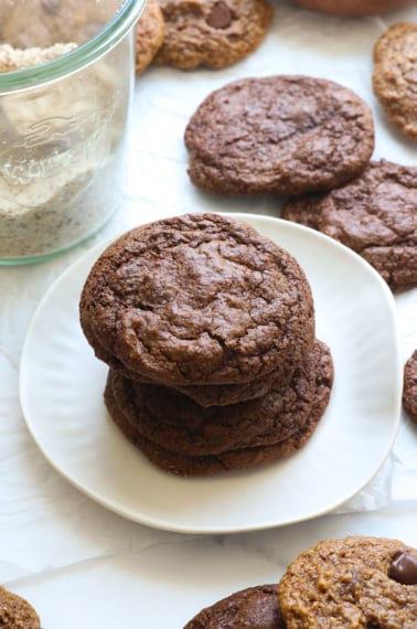 almond meal cookies stacked on a white plate.